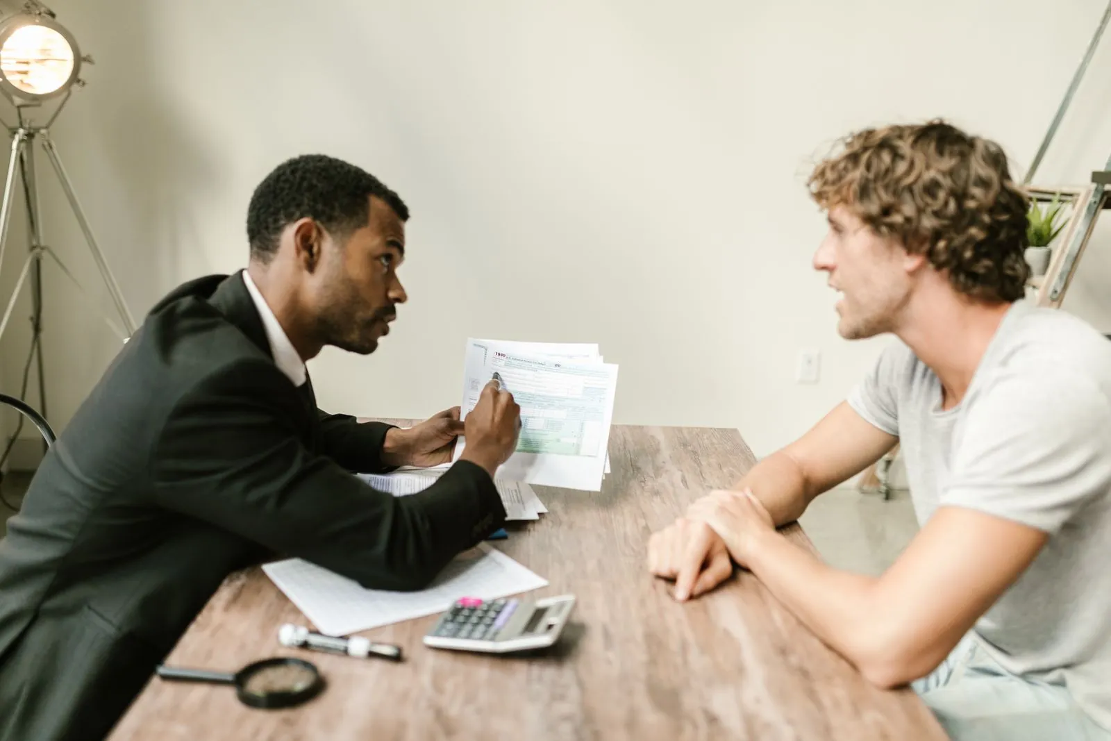 An adviser discusses documents with a client.