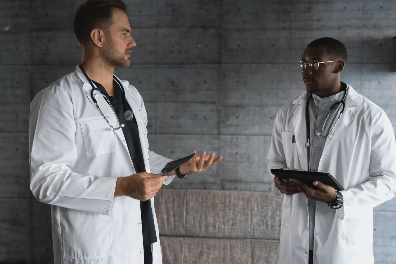 Two doctors discuss research and patient care.