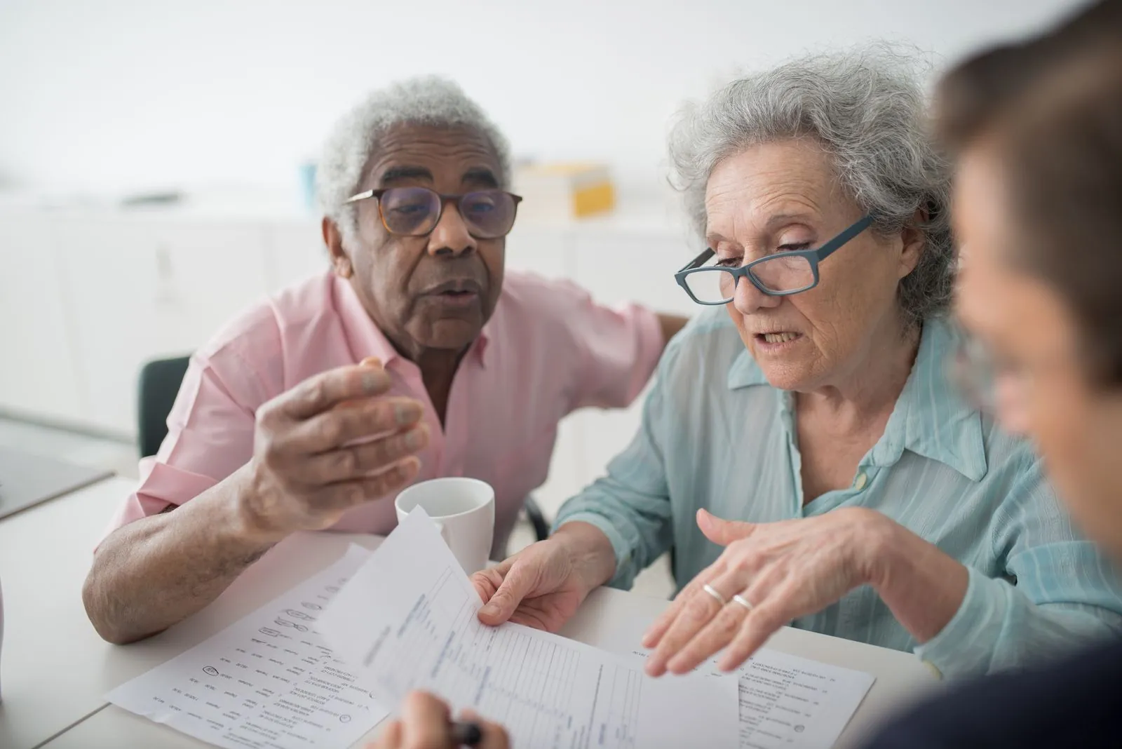 Older adults review documents with an adviser.